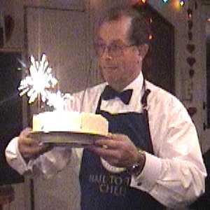 Nigel Knowles serving a sparkling Gateau