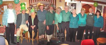Members wearing a St Patrick Day green dress theme
