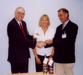 Frank Rainsborough presenting the AQSC cheque for £700 to Graeme Love, the Blind Sailing Representative, with Debbie Blachord the RYA Sailability Manager.